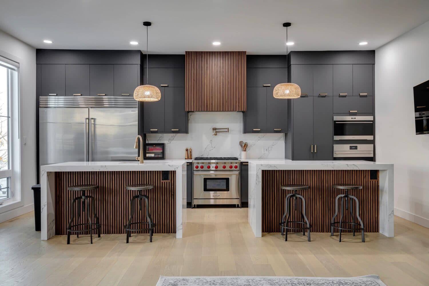 Gargoyle House chef's kitchen with Wolf range and fluted walnut islands