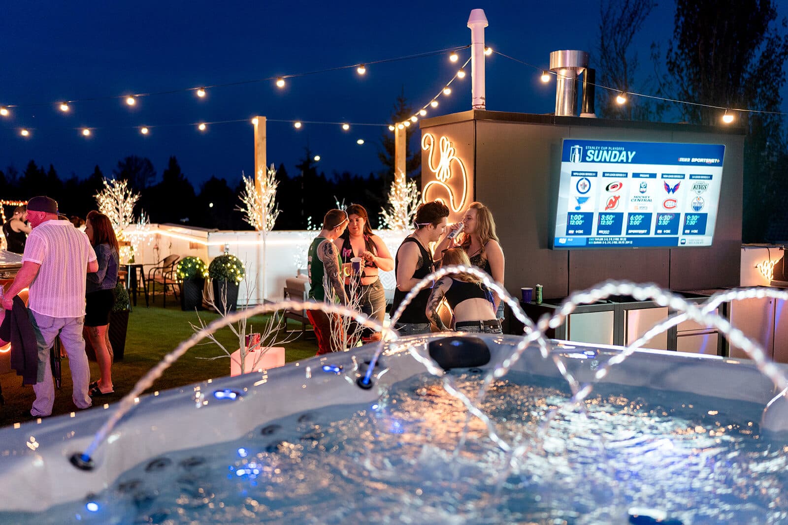 Rooftop event at the Gargoyle House with outdoor screen and hot tub