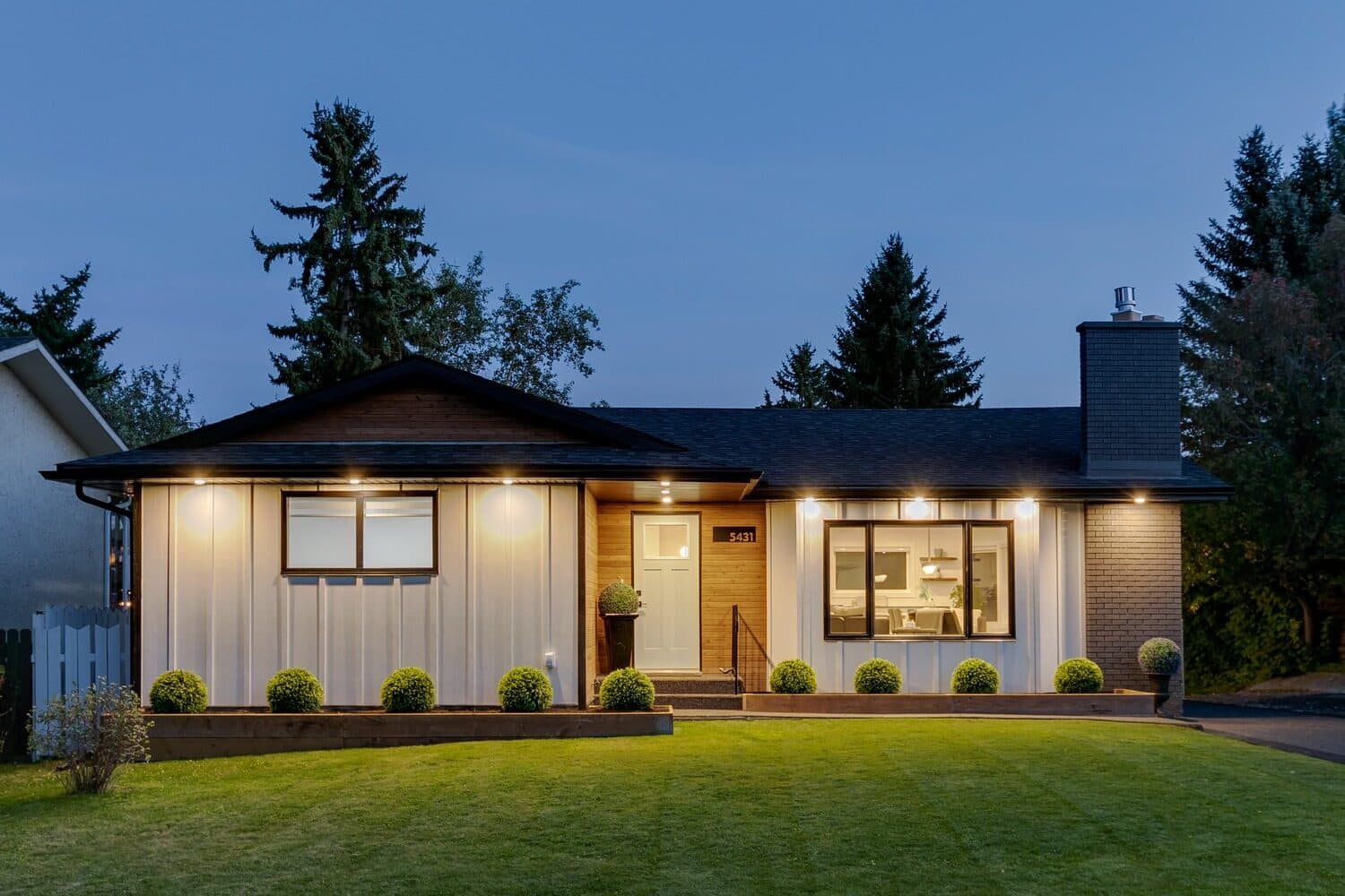 Renovated bungalow exterior at dusk on Bannerman Drive NW, Calgary