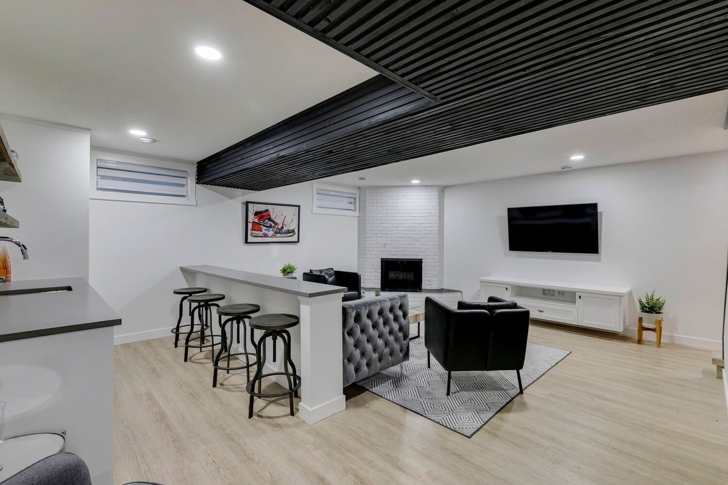 Bannerman Drive basement media room with slat ceiling and bar