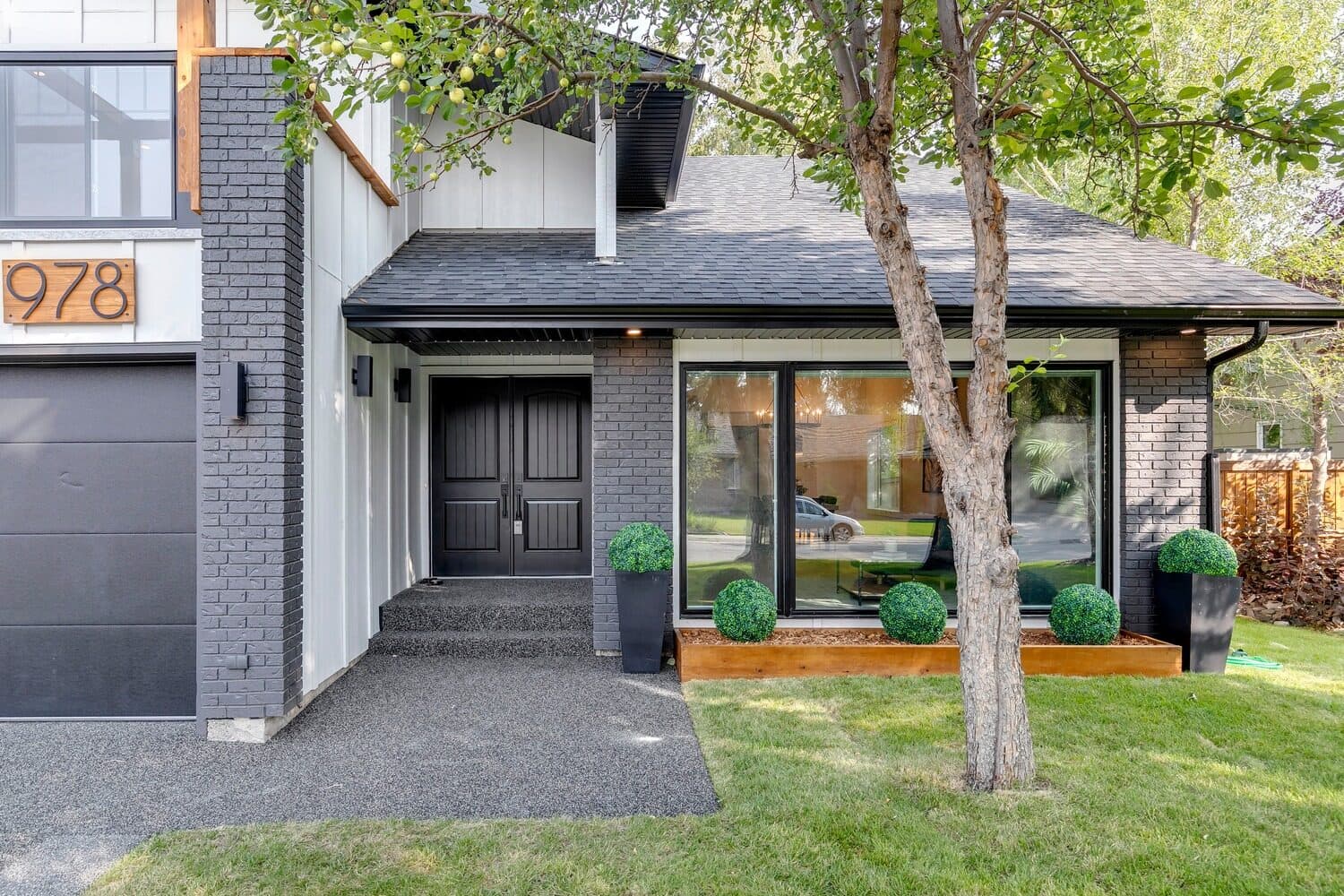 Renovated two-storey home with black brick and glass entry, Lake Placid Drive SE