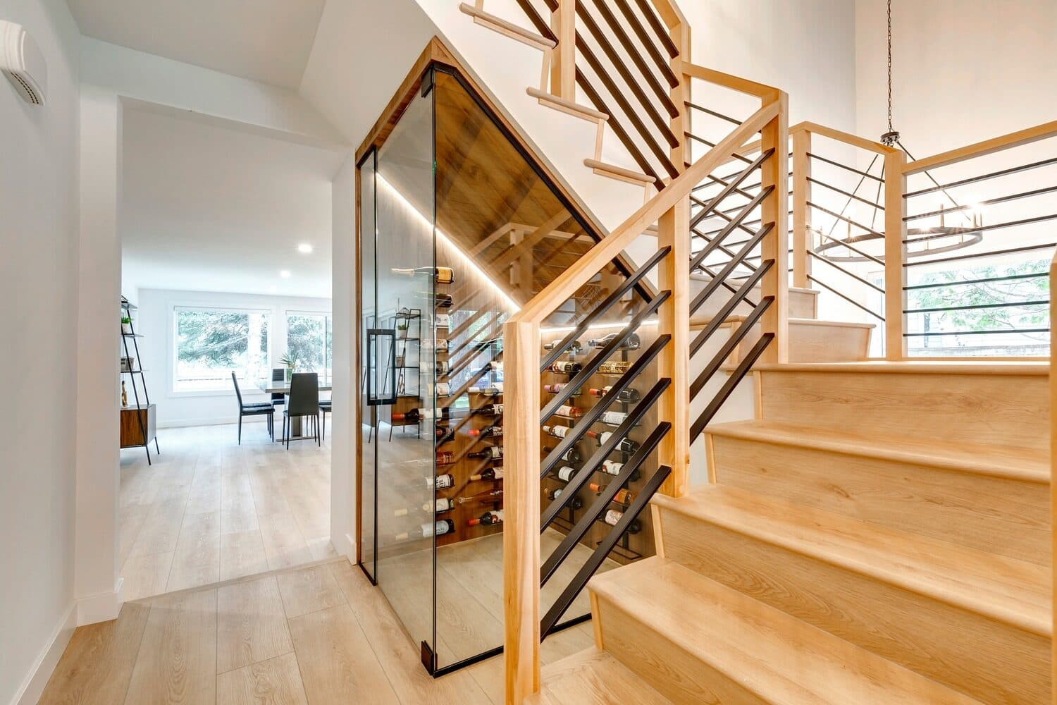 Glass-walled wine display beside the staircase — Lake Placid