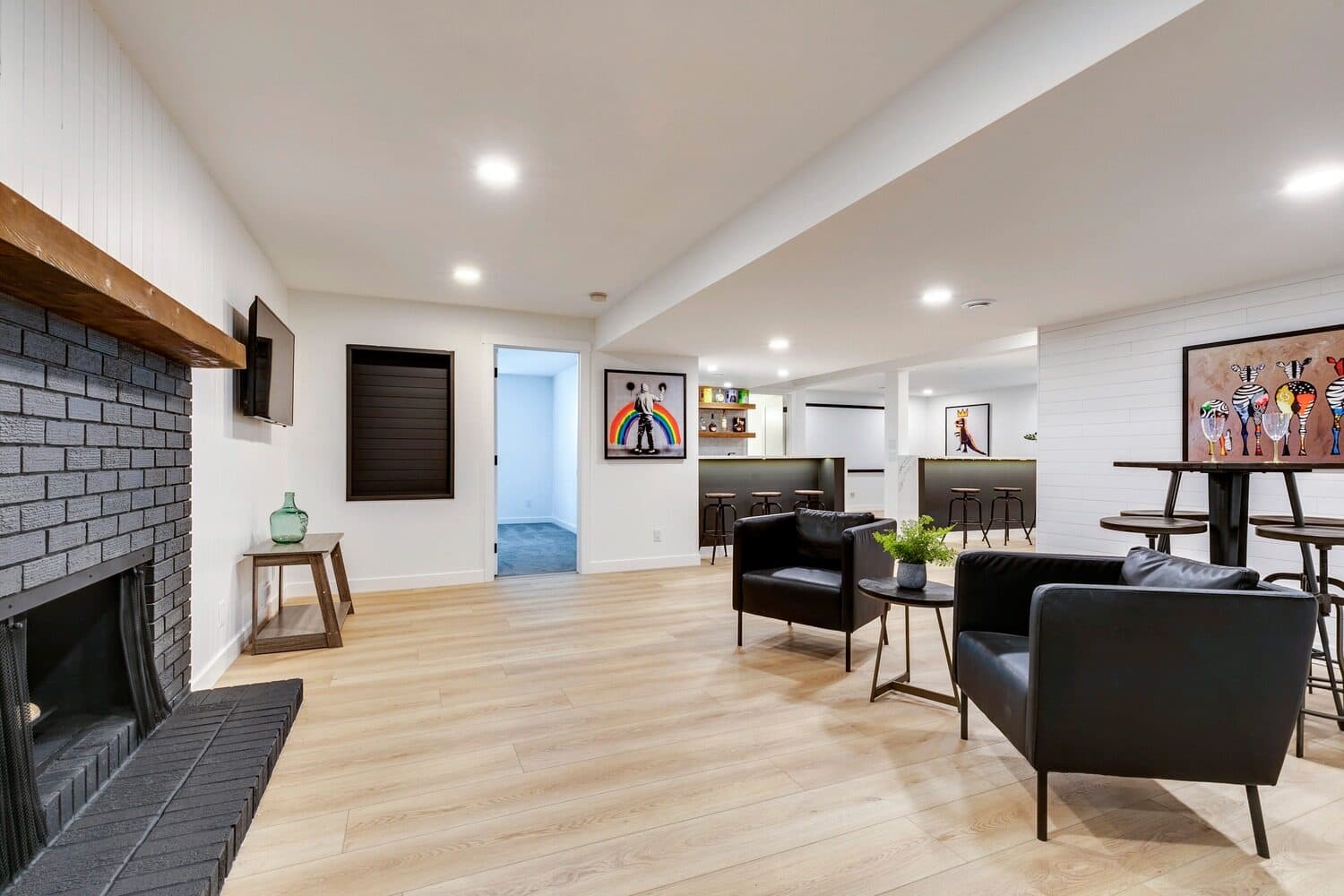 Lake Placid basement lounge with black brick fireplace
