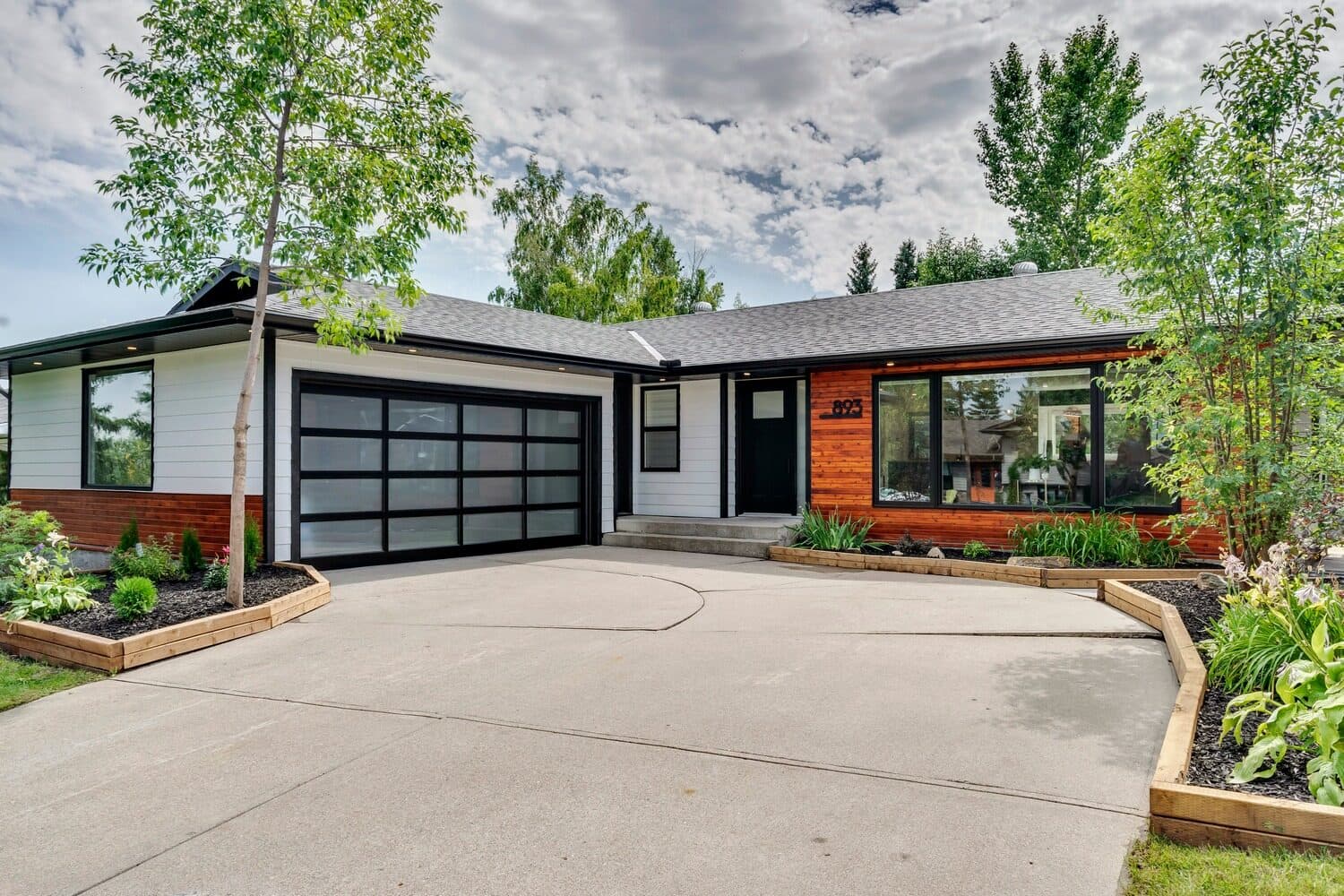 Modern renovated bungalow with glass garage door in Parkland, Calgary SE