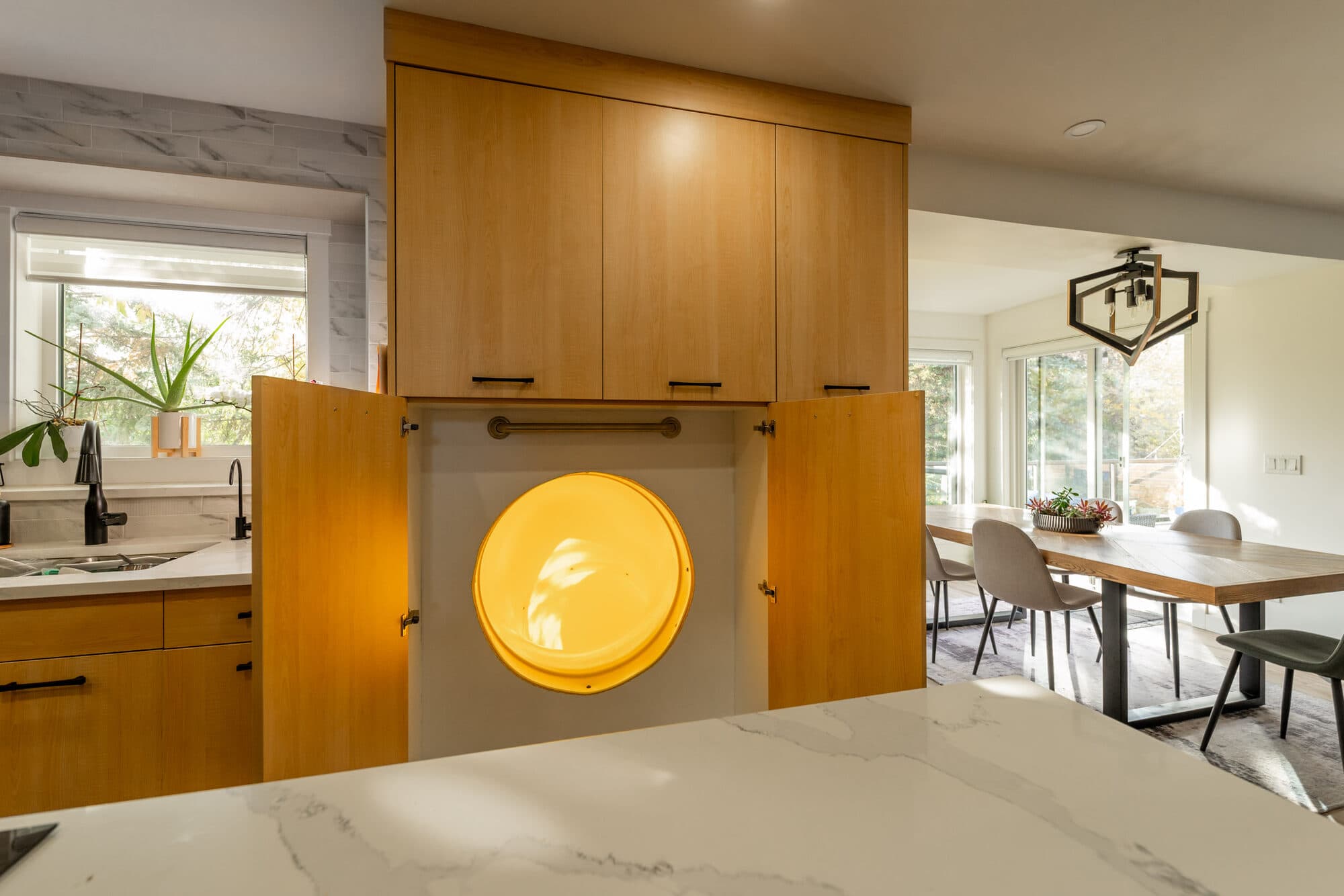 Slide entrance hidden behind a cabinet door in the main-floor kitchen