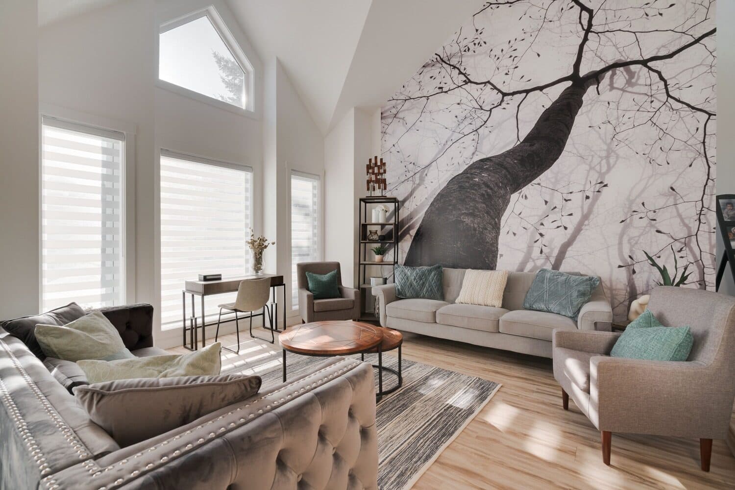 Slide House main-floor living room with vaulted ceiling and tree mural wall