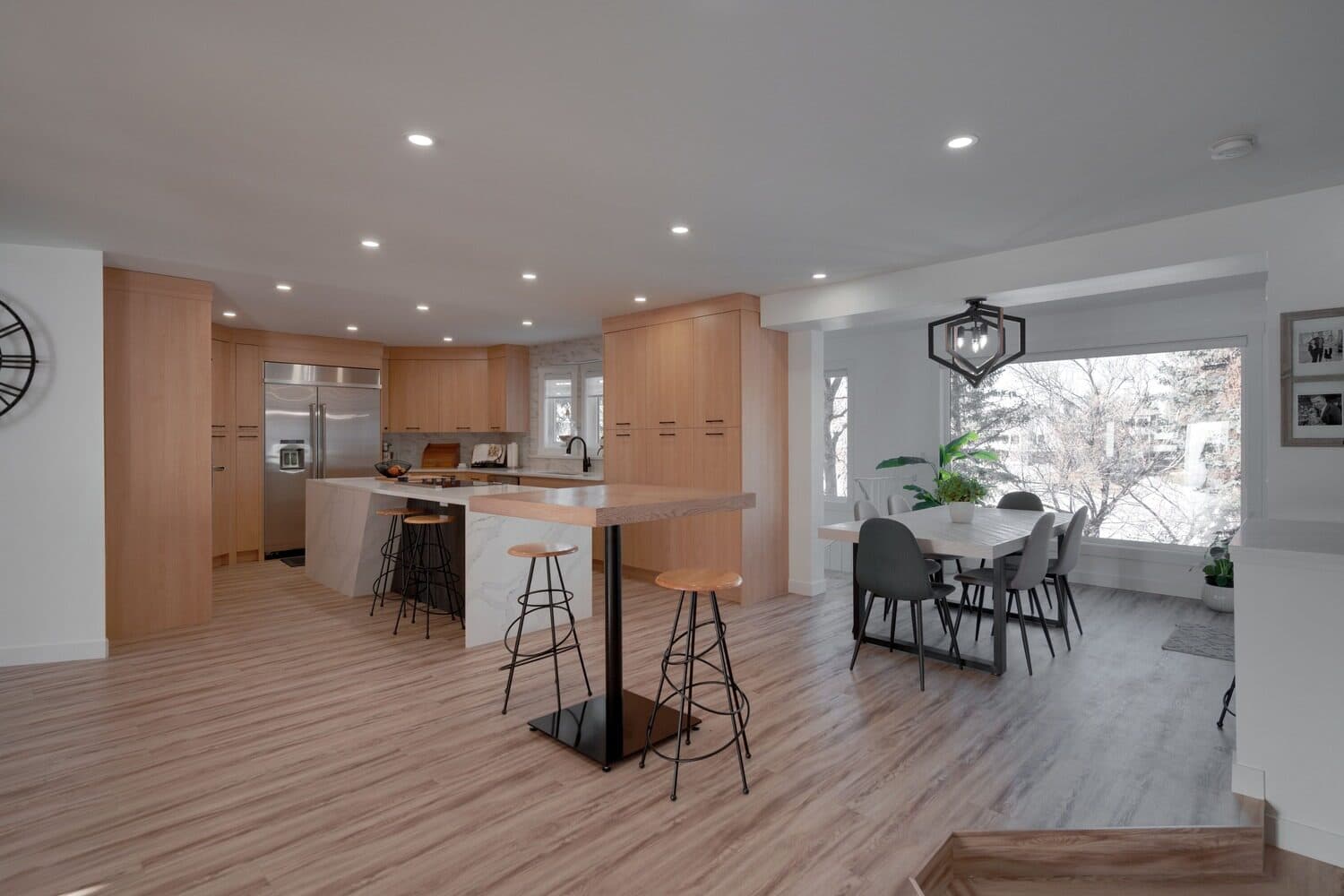 Slide House main-floor kitchen with wood island and open dining