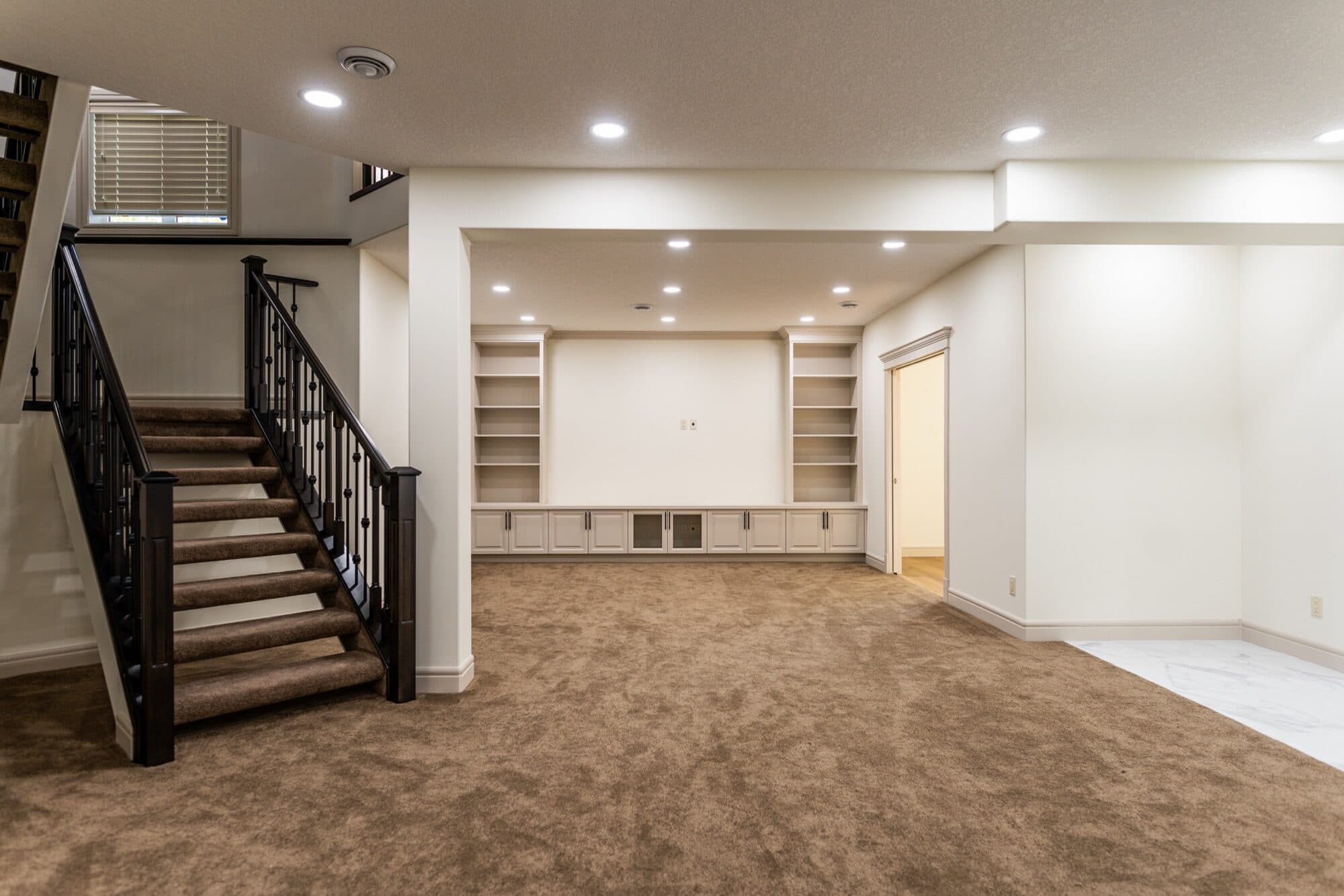 Large basement games room with a pool table, arcade machine and wet bar