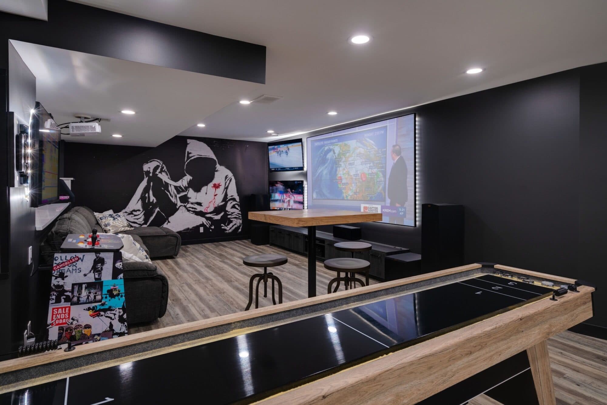 Basement rec room with mural feature wall and shuffleboard table