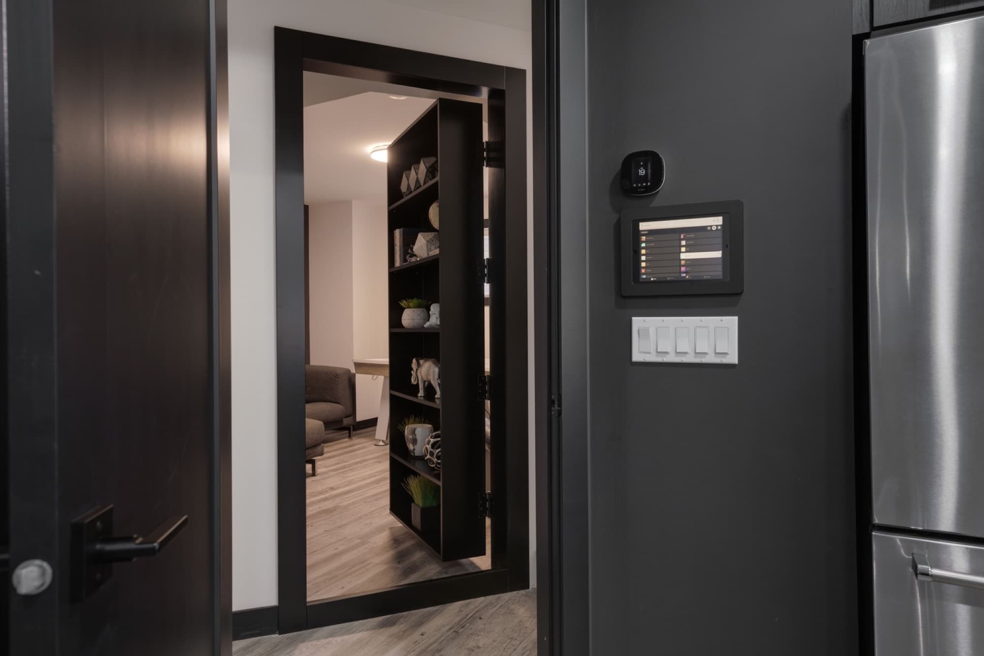 Basement hidden bookcase door with smart home control panel
