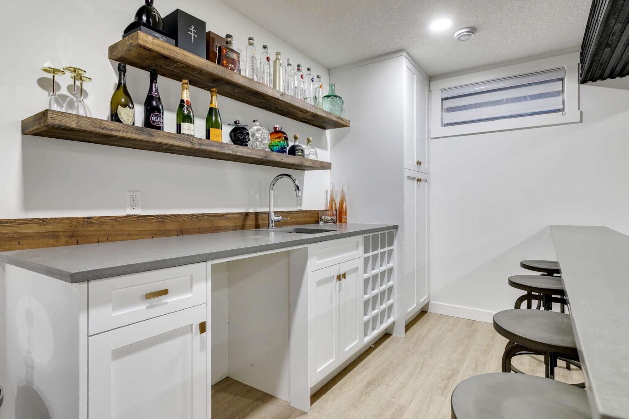 White basement bar with wood shelves and wine storage
