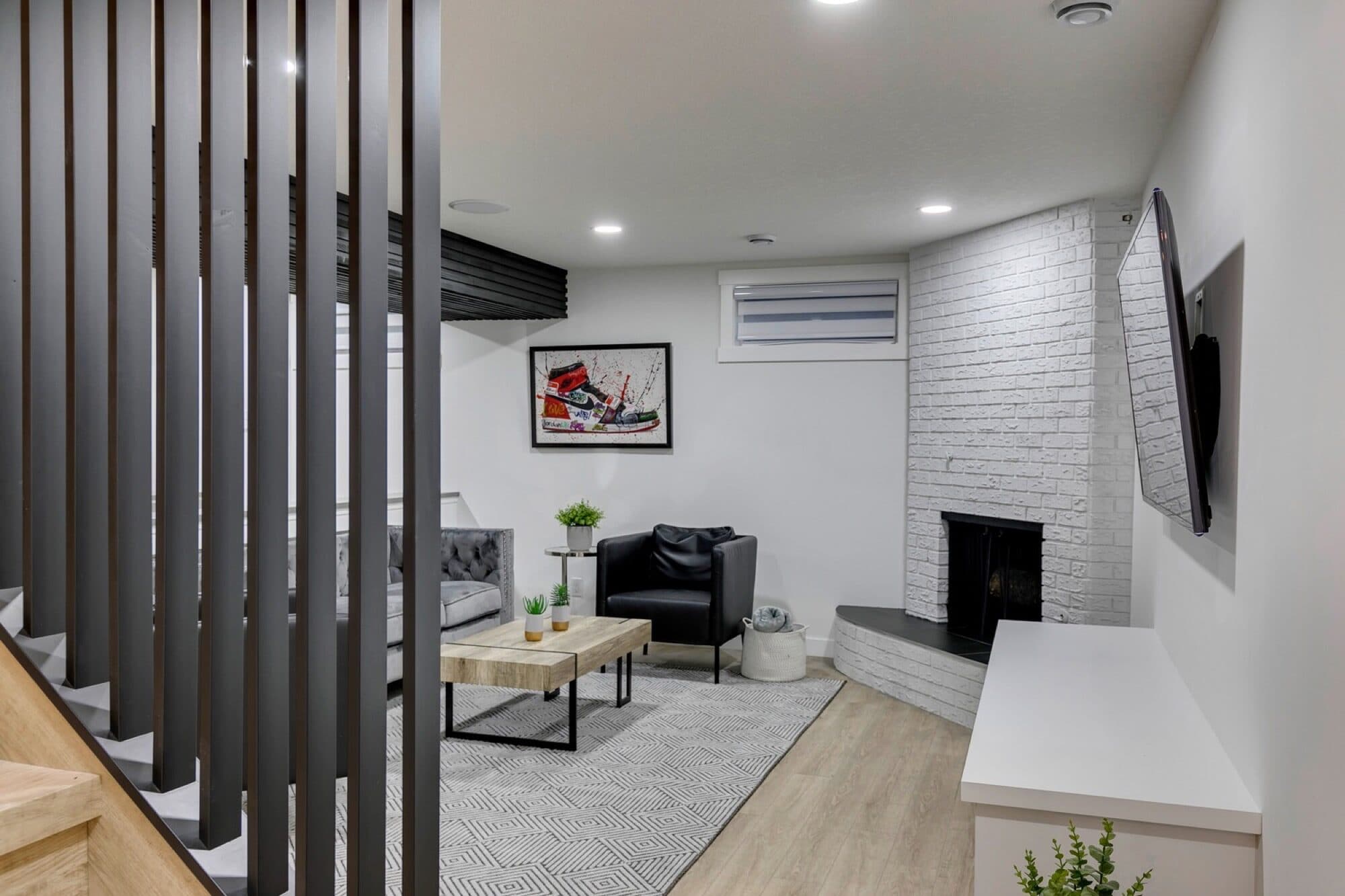 Basement rec room viewed through steel staircase railing