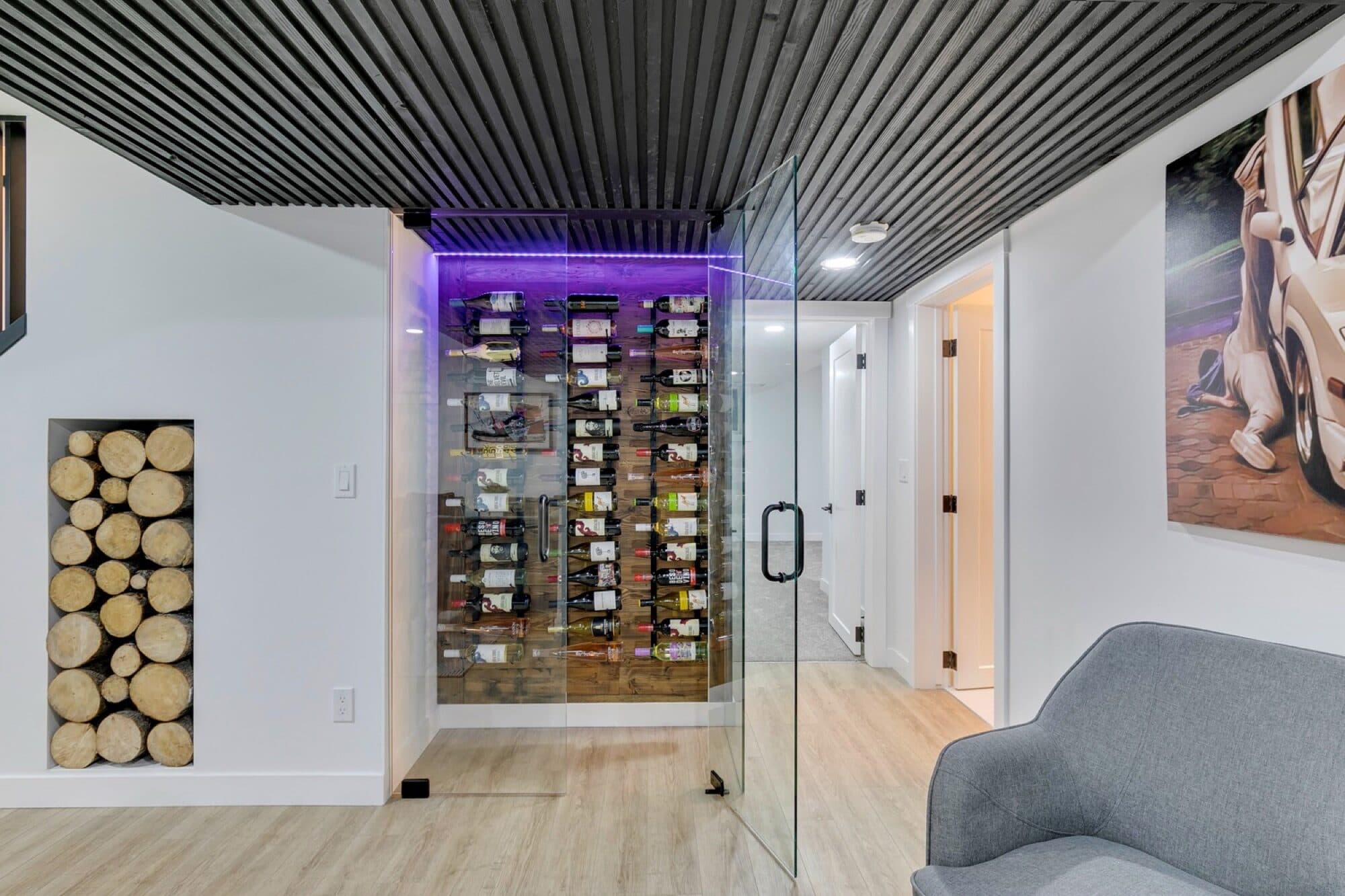 Glass-enclosed basement wine room with purple LED lighting