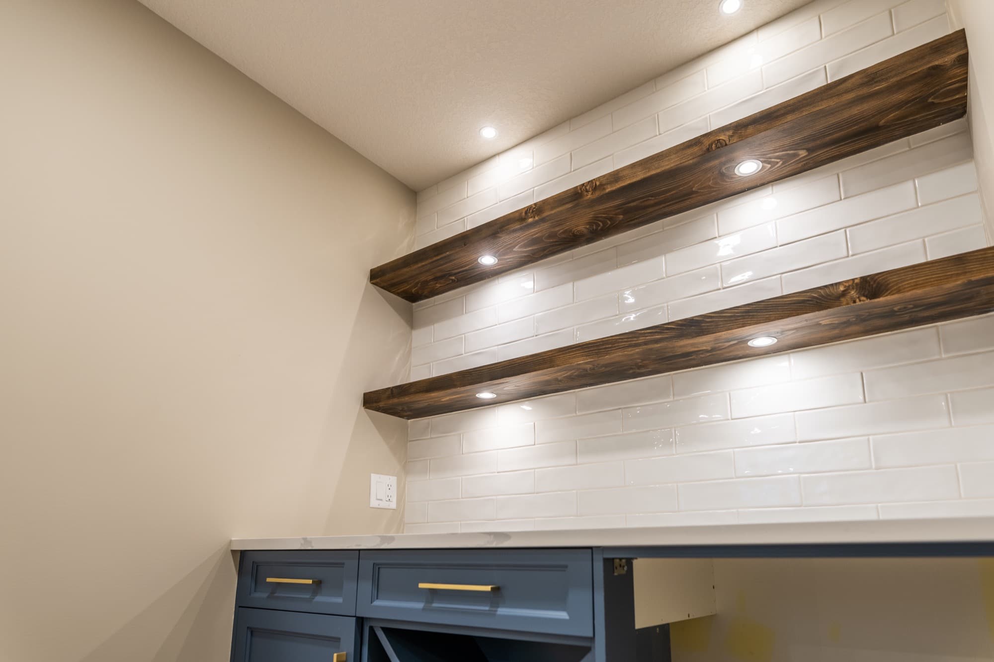 Illuminated bar shelves with subway tile and blue LED lighting