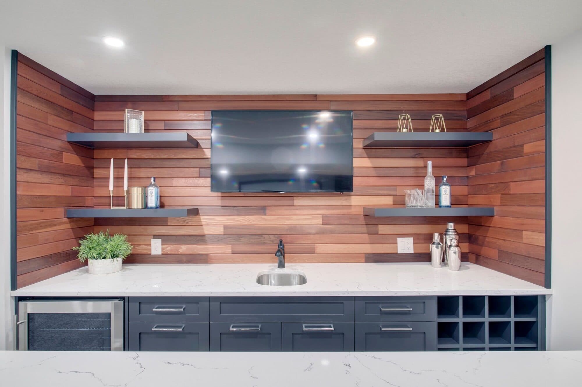 Basement bar wide angle with wood accent wall and wine storage