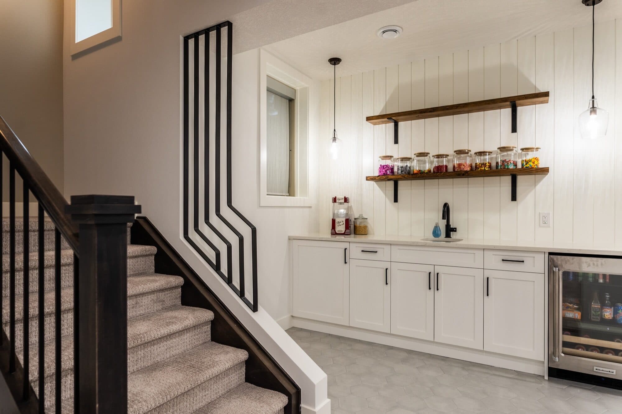 Basement bar and staircase with designer pendant lighting