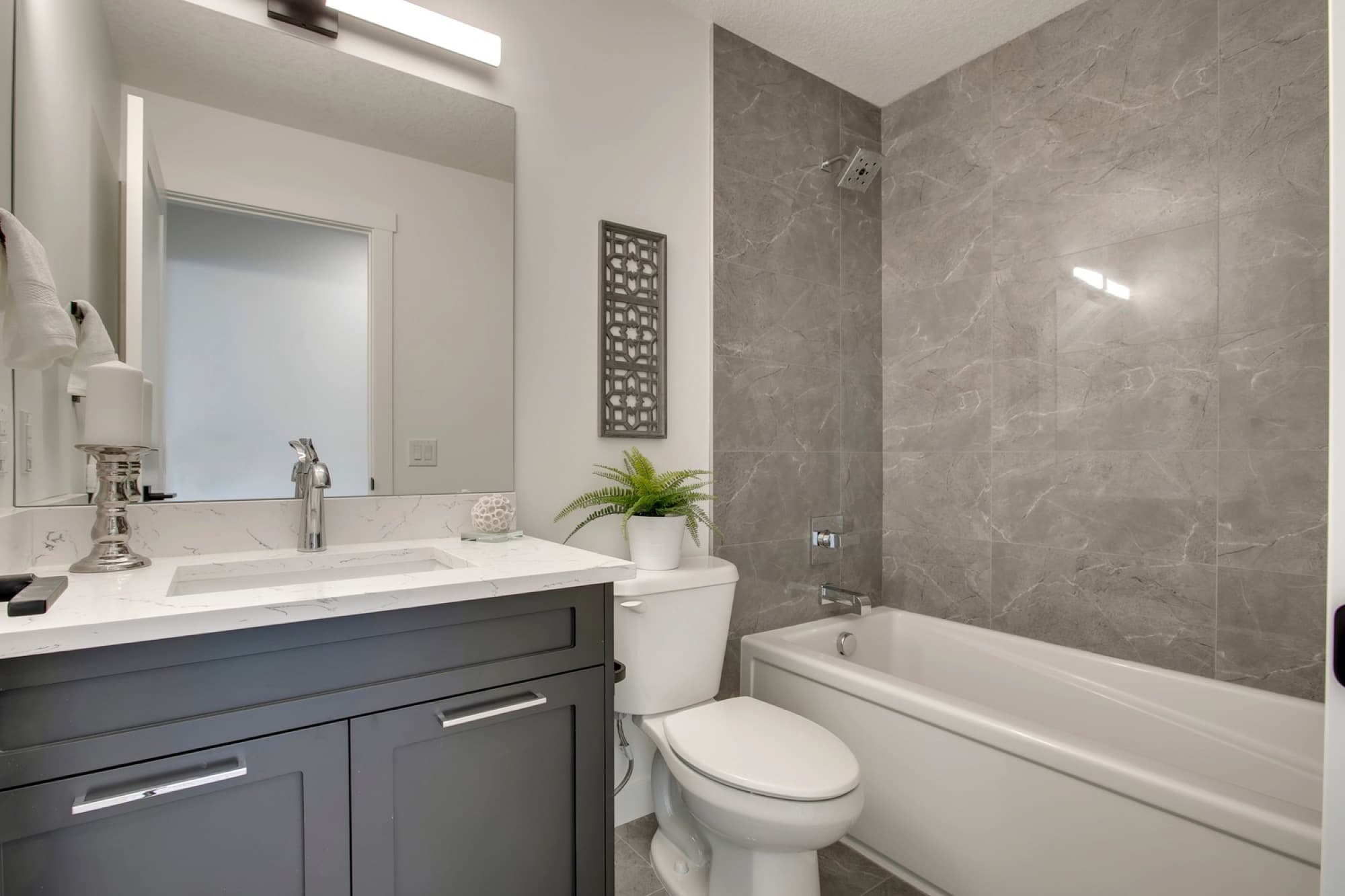 Finished basement bathroom with a tiled tub-shower
