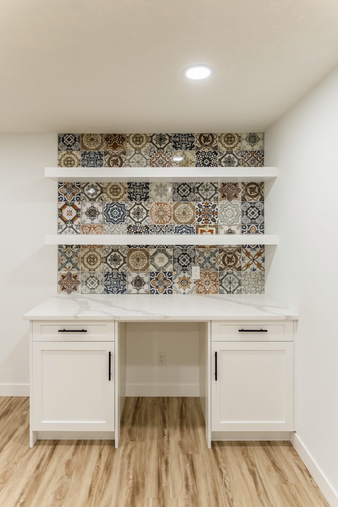 Basement built-in desk with colourful Moroccan patchwork tile backsplash