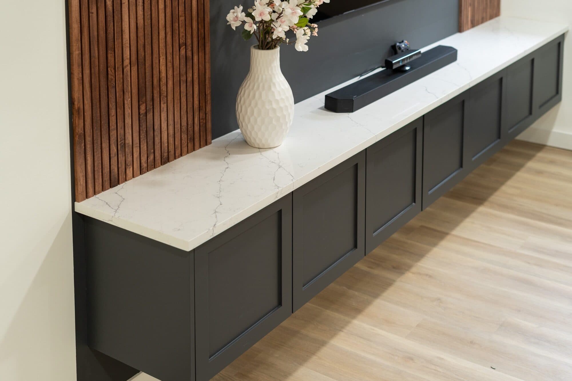 Basement floating cabinet with marble quartz top and wood slat accent