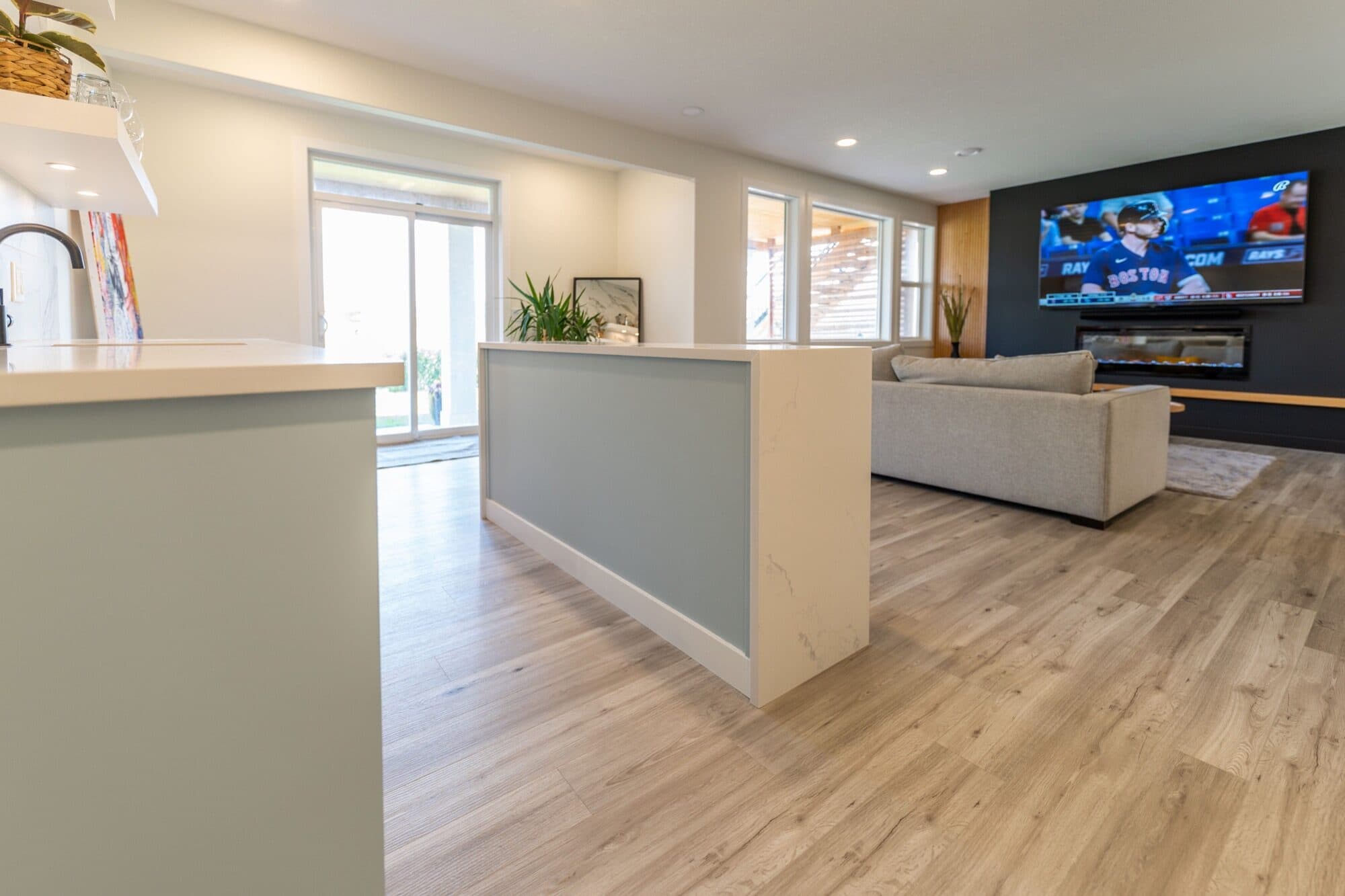 Basement rec room with black fireplace feature wall and floating shelves