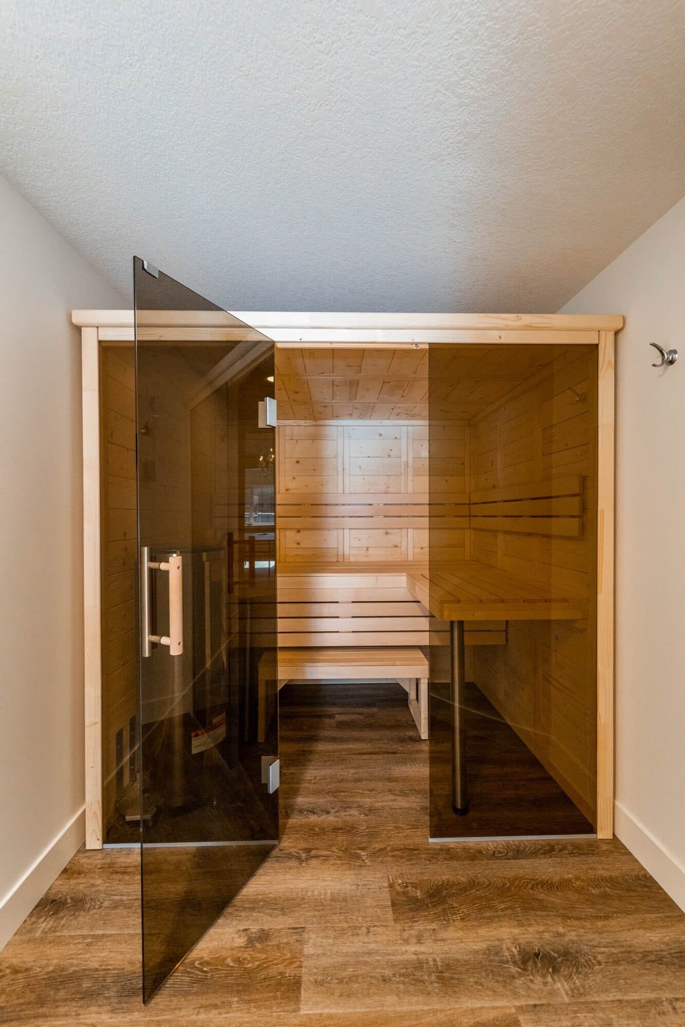 Basement cedar sauna with glass door and tiled floor