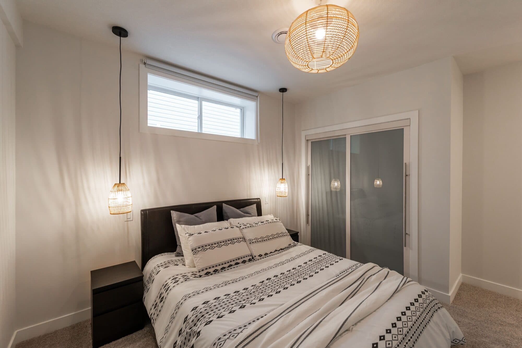 Legal suite bedroom with boho pendant lights and sliding closet doors