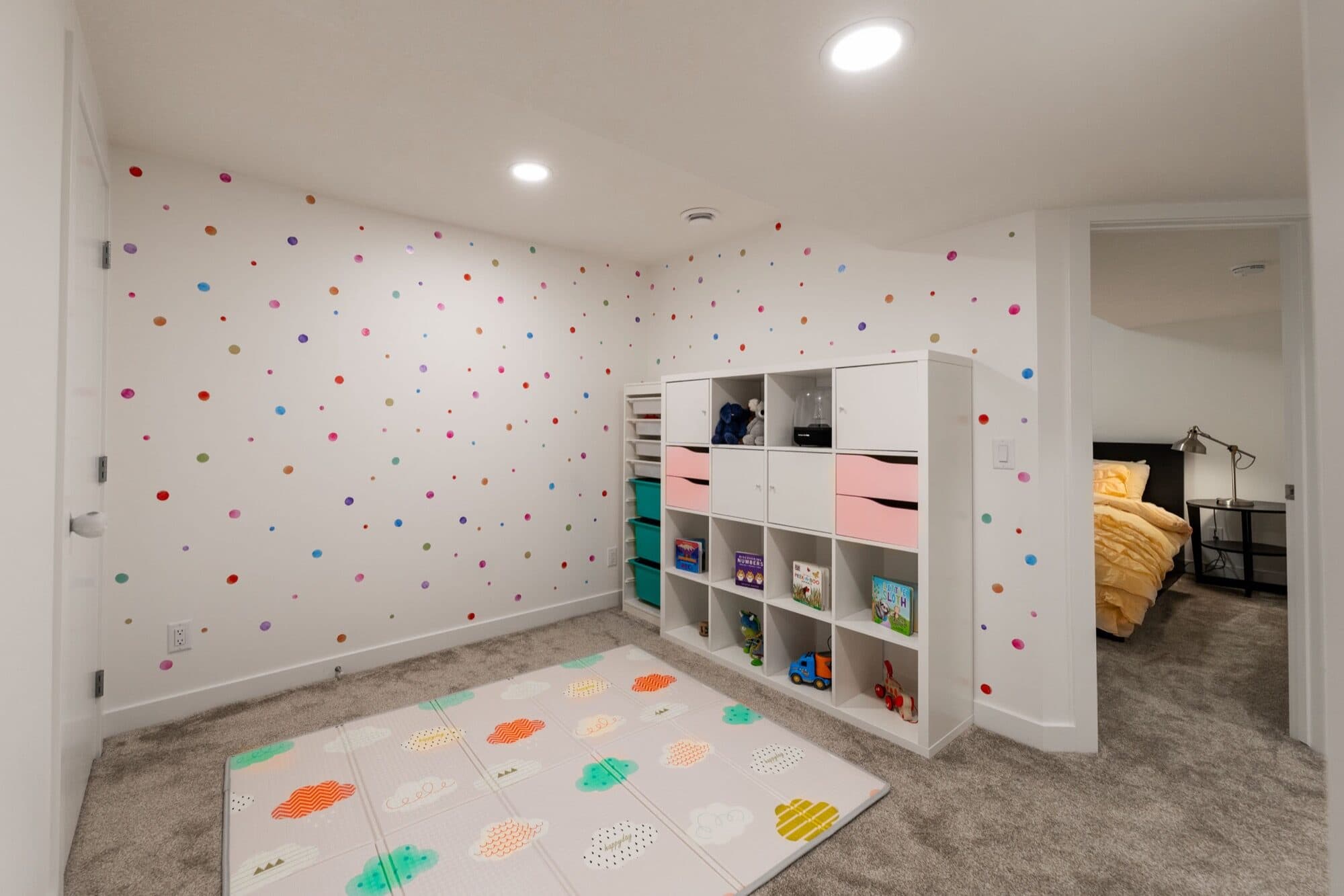 Legal suite kids playroom with polka dot wall and bedroom beyond