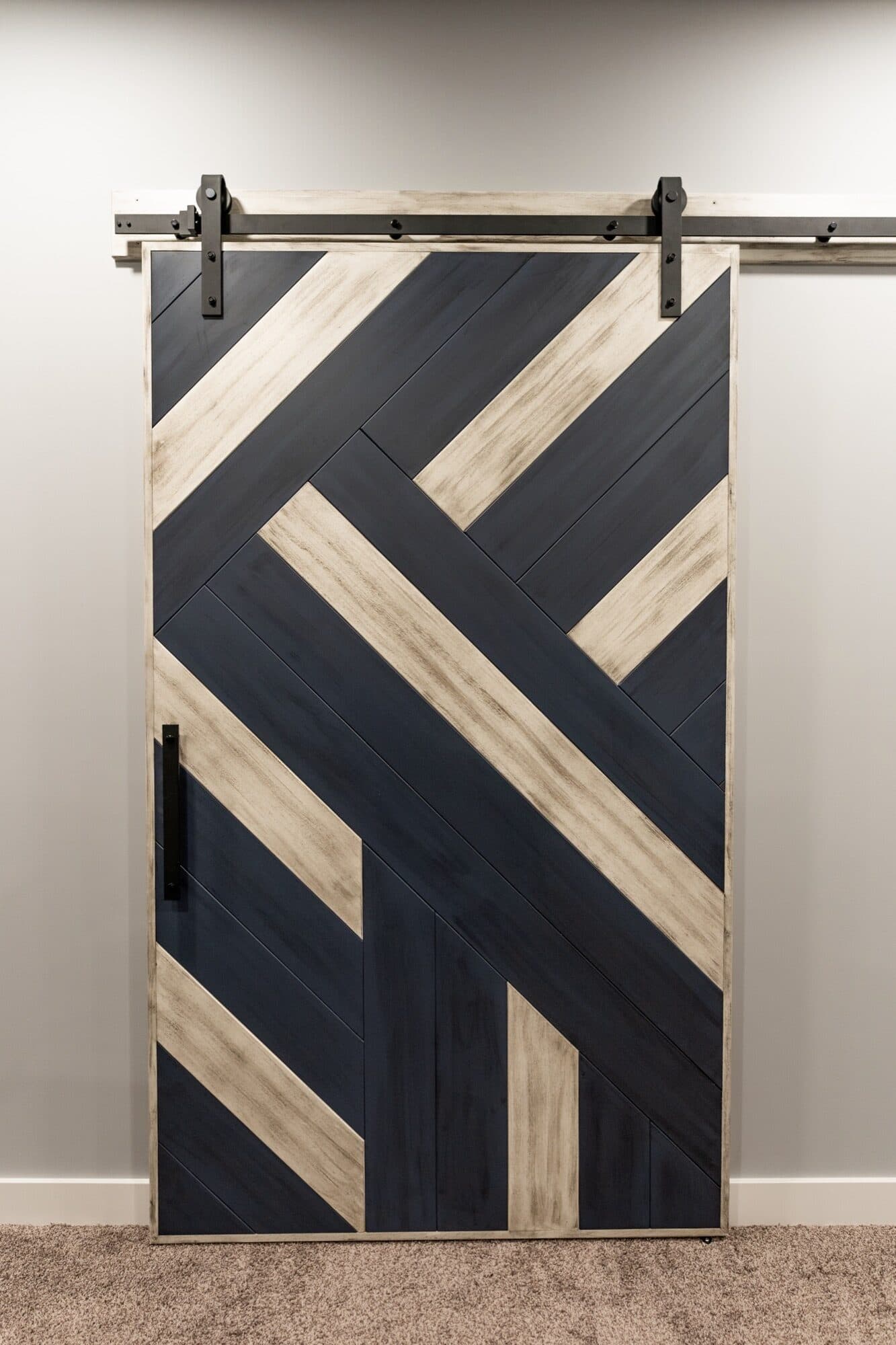 Two-tone geometric barn door in blue and natural wood