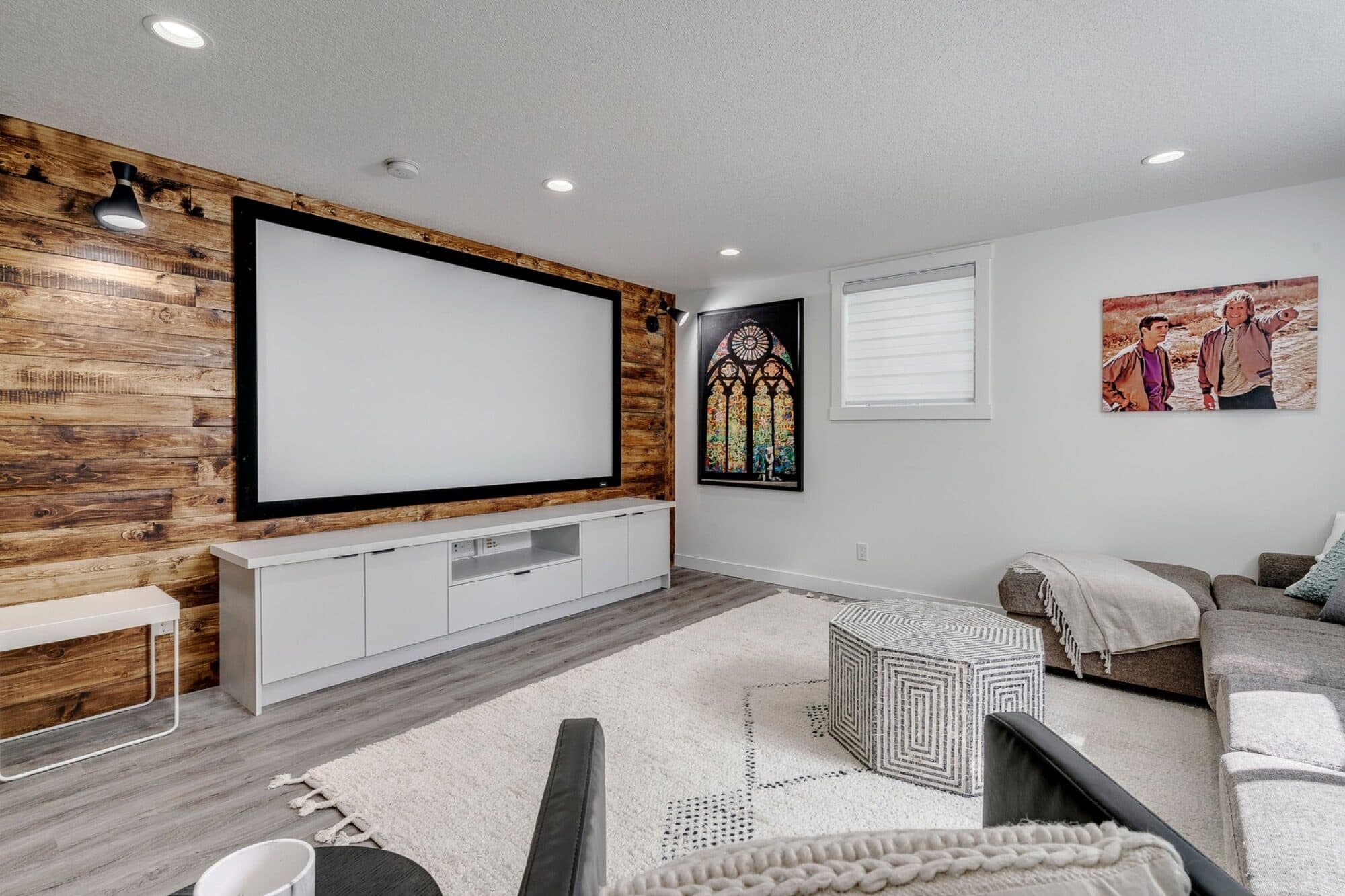 Basement home theatre with reclaimed wood accent wall and screen