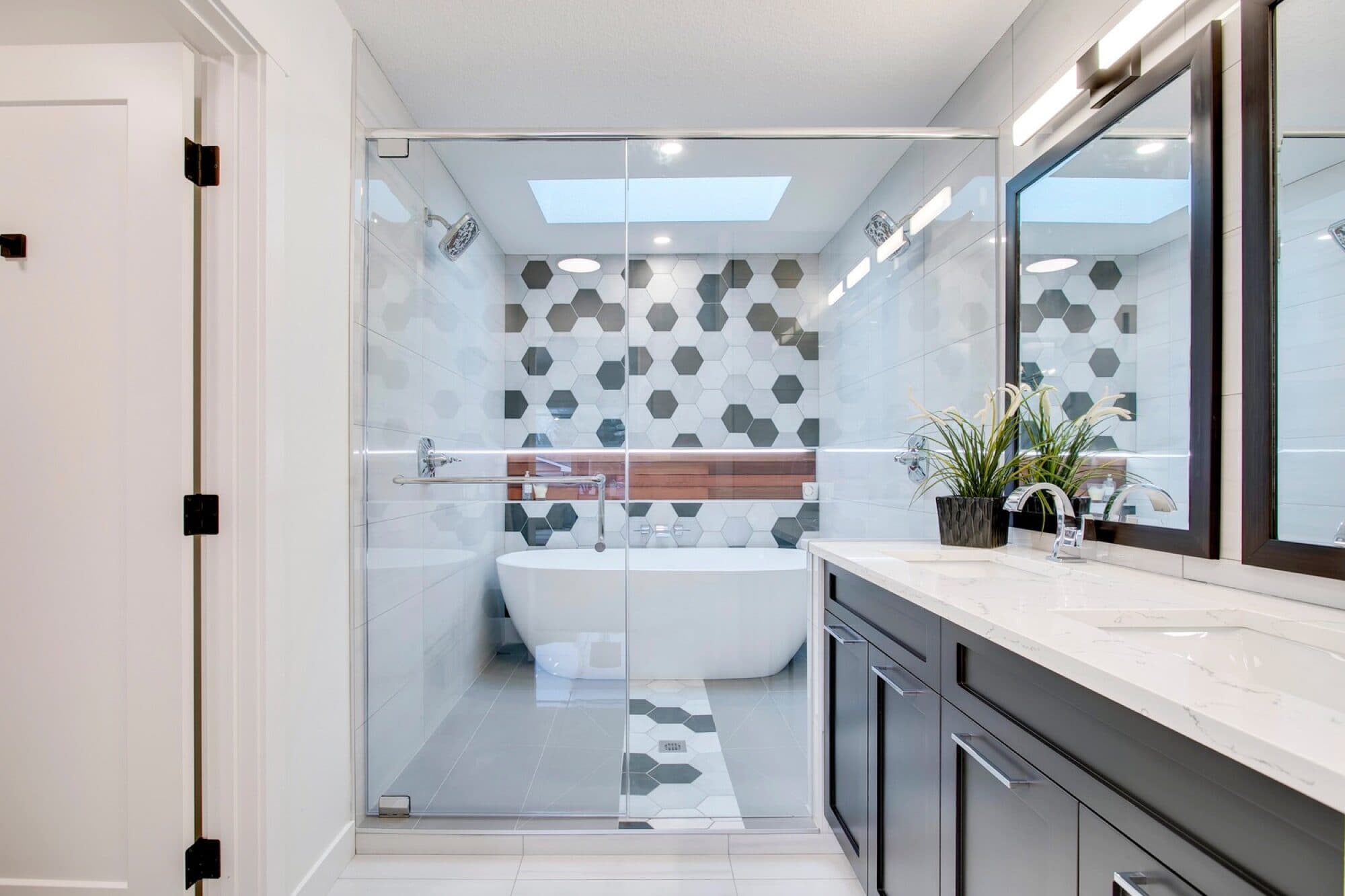 Ensuite with hexagon tile and soaker tub inside glass shower