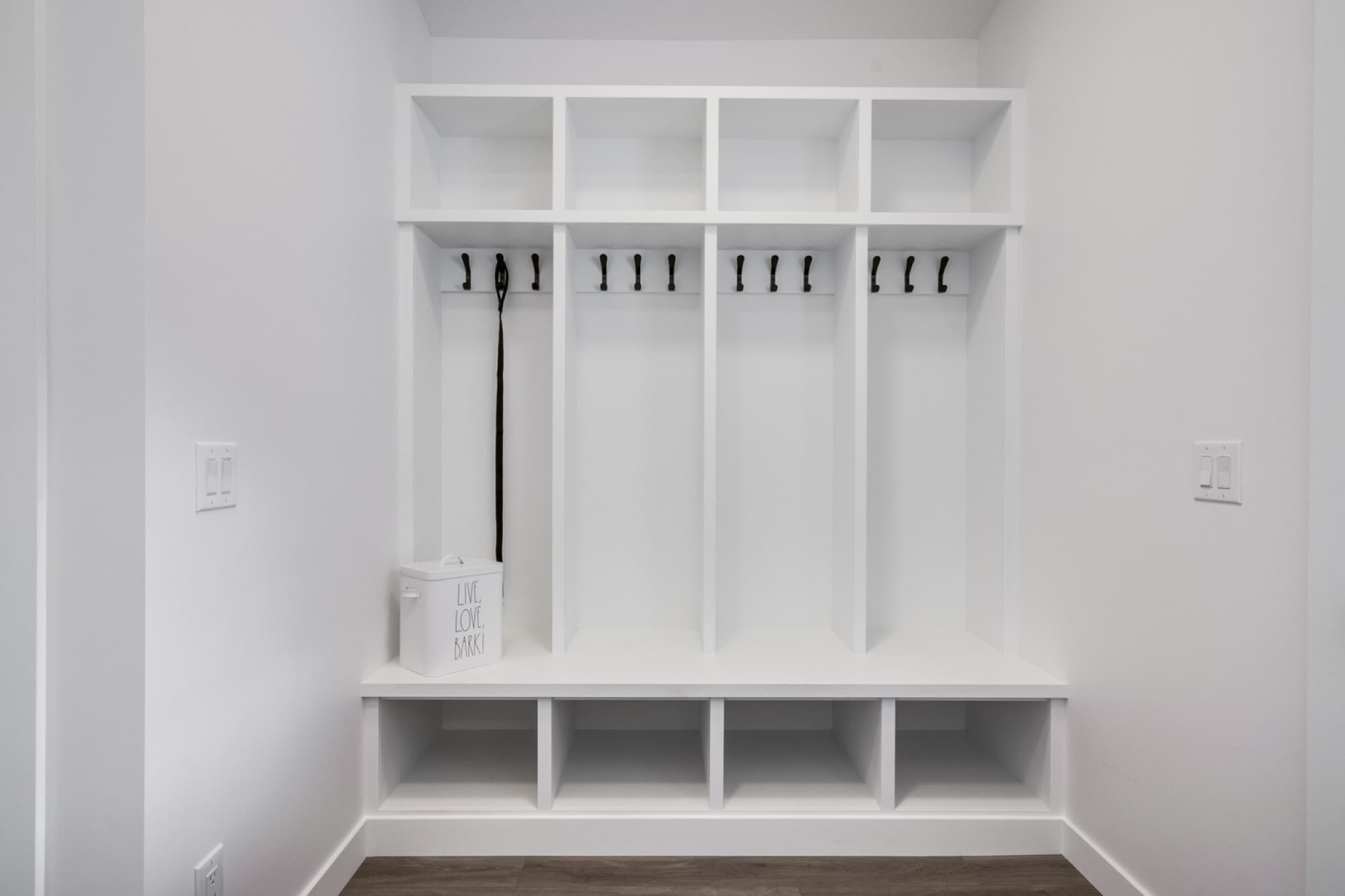 Built-in mudroom locker system with open cubbies and bench