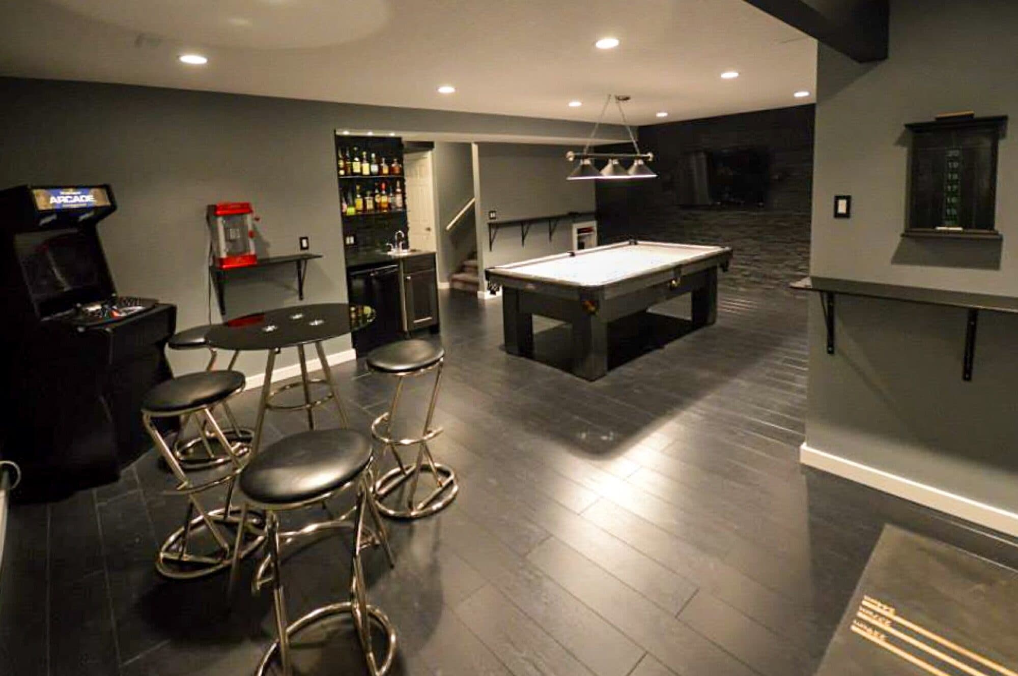 Basement rec room with pool table, arcade and bar