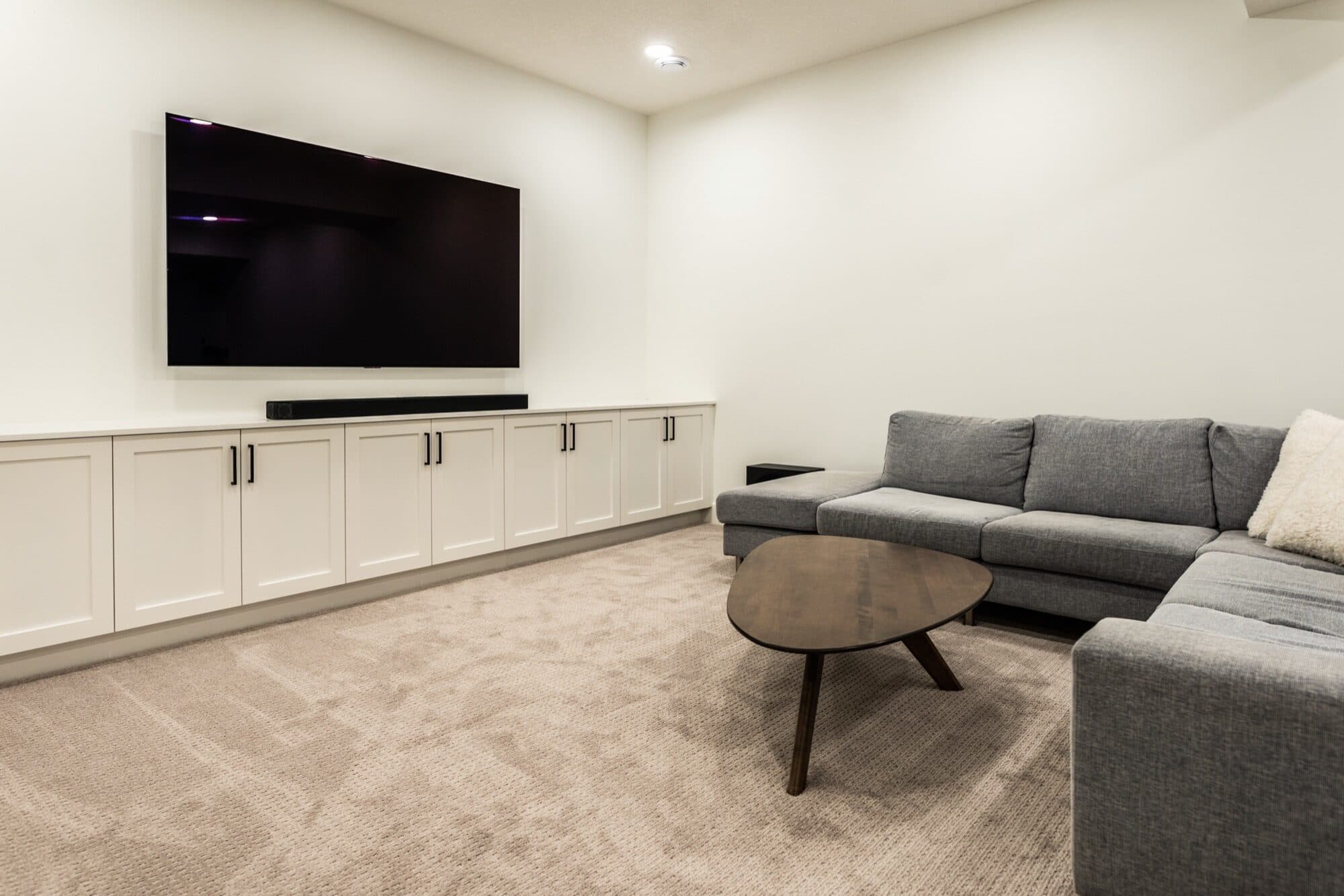 Basement rec room corner angle with full sectional and coffee table