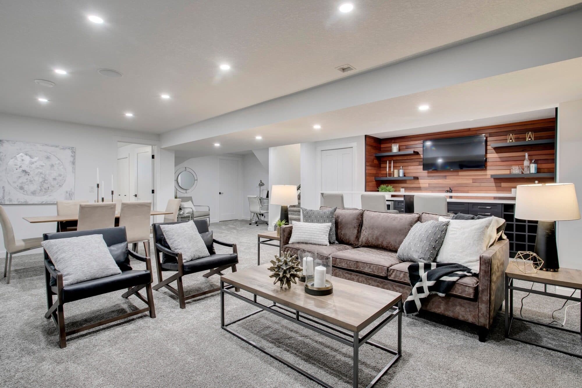 Basement rec room with sofa, dining area and bar nook
