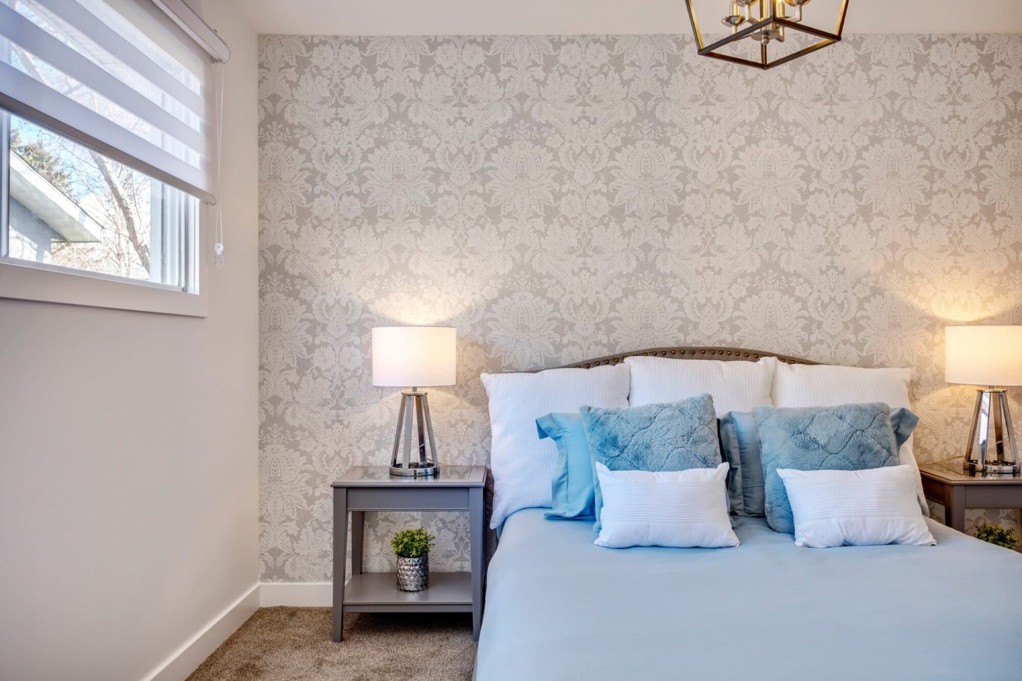 Legal suite bedroom with damask wallpaper accent wall