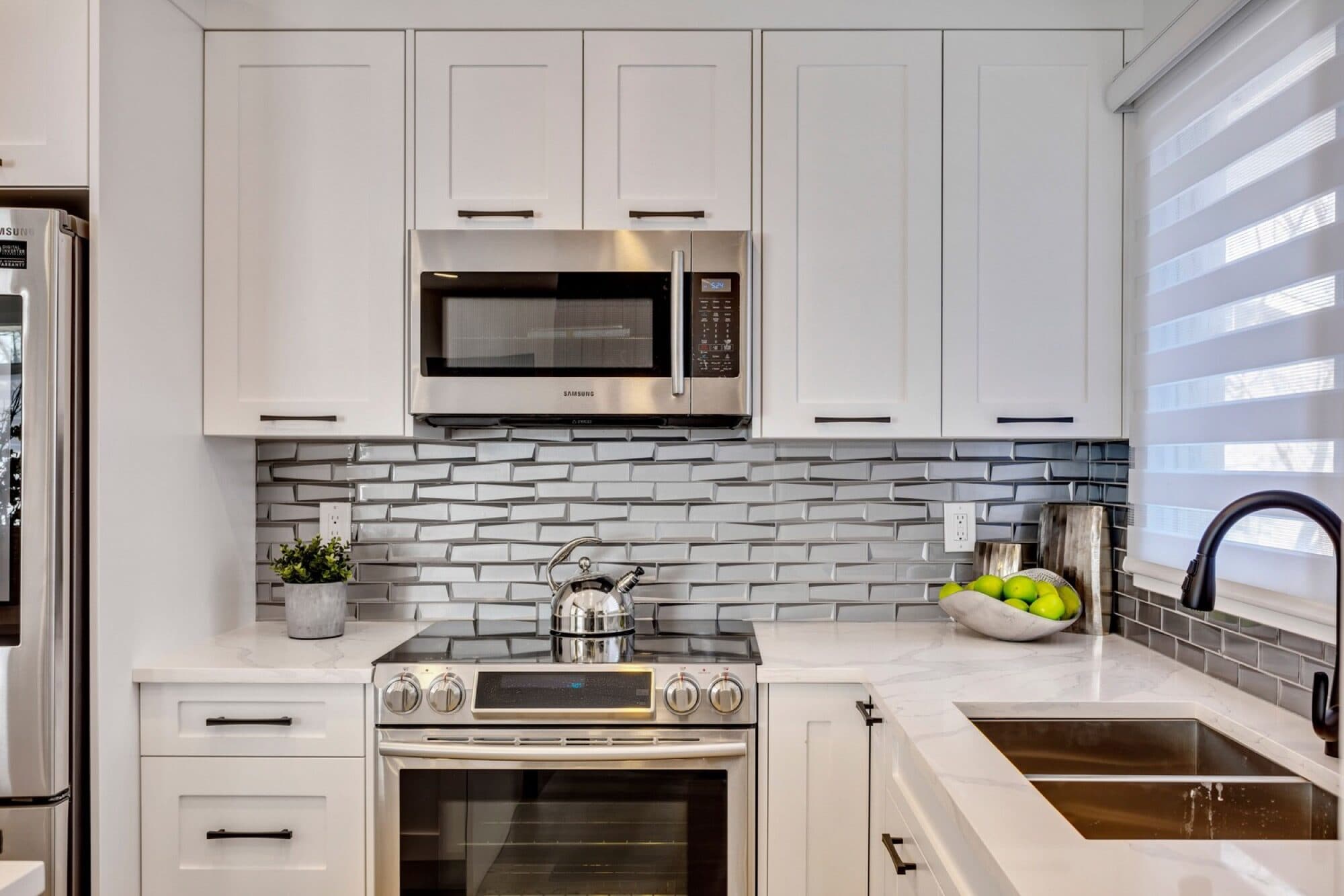 Legal suite kitchen with white cabinets and subway tile backsplash
