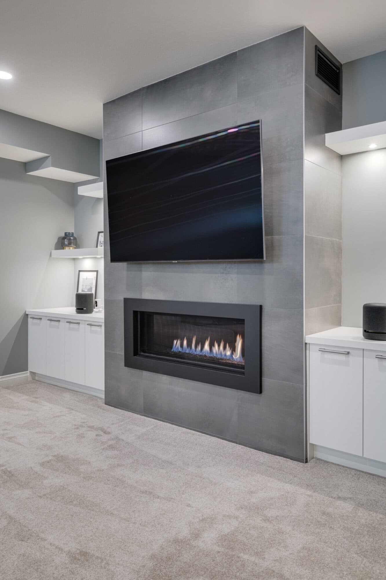Basement feature wall with linear fireplace and floating TV
