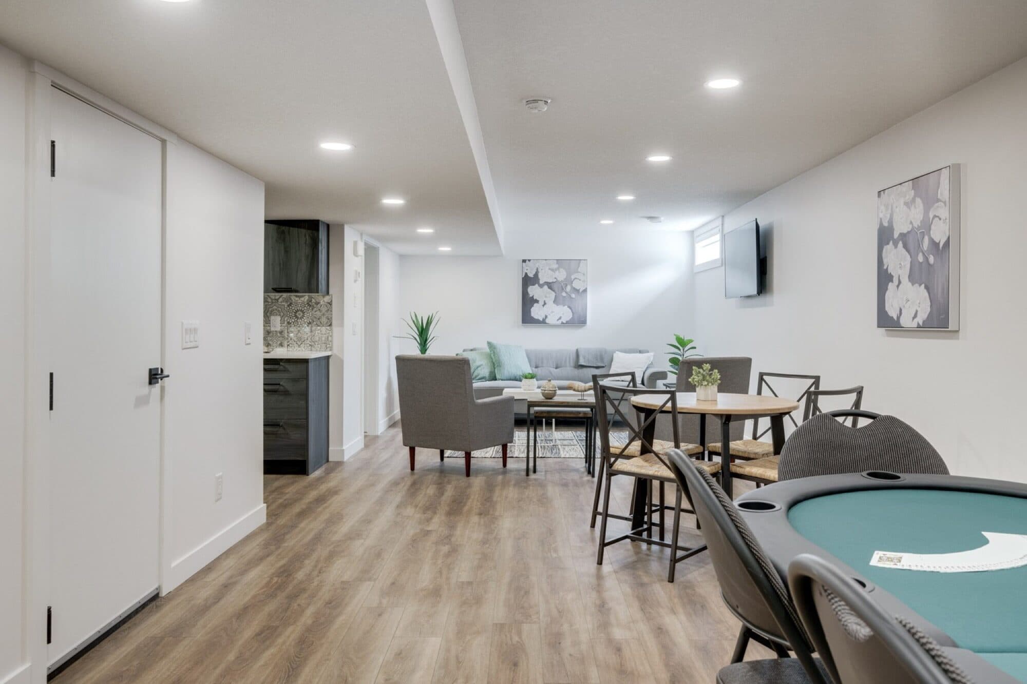 Legal suite open rec room with poker table and sofa area