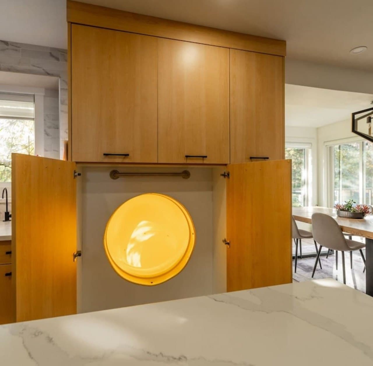 Hidden main-floor slide entrance concealed behind custom kitchen cabinetry