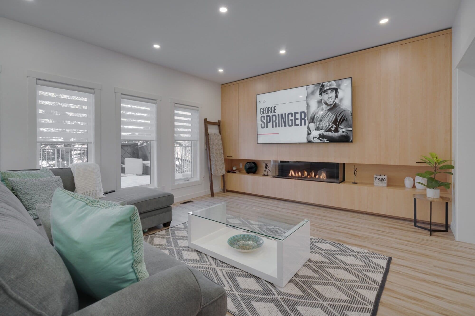 Living room with wood feature wall and linear fireplace