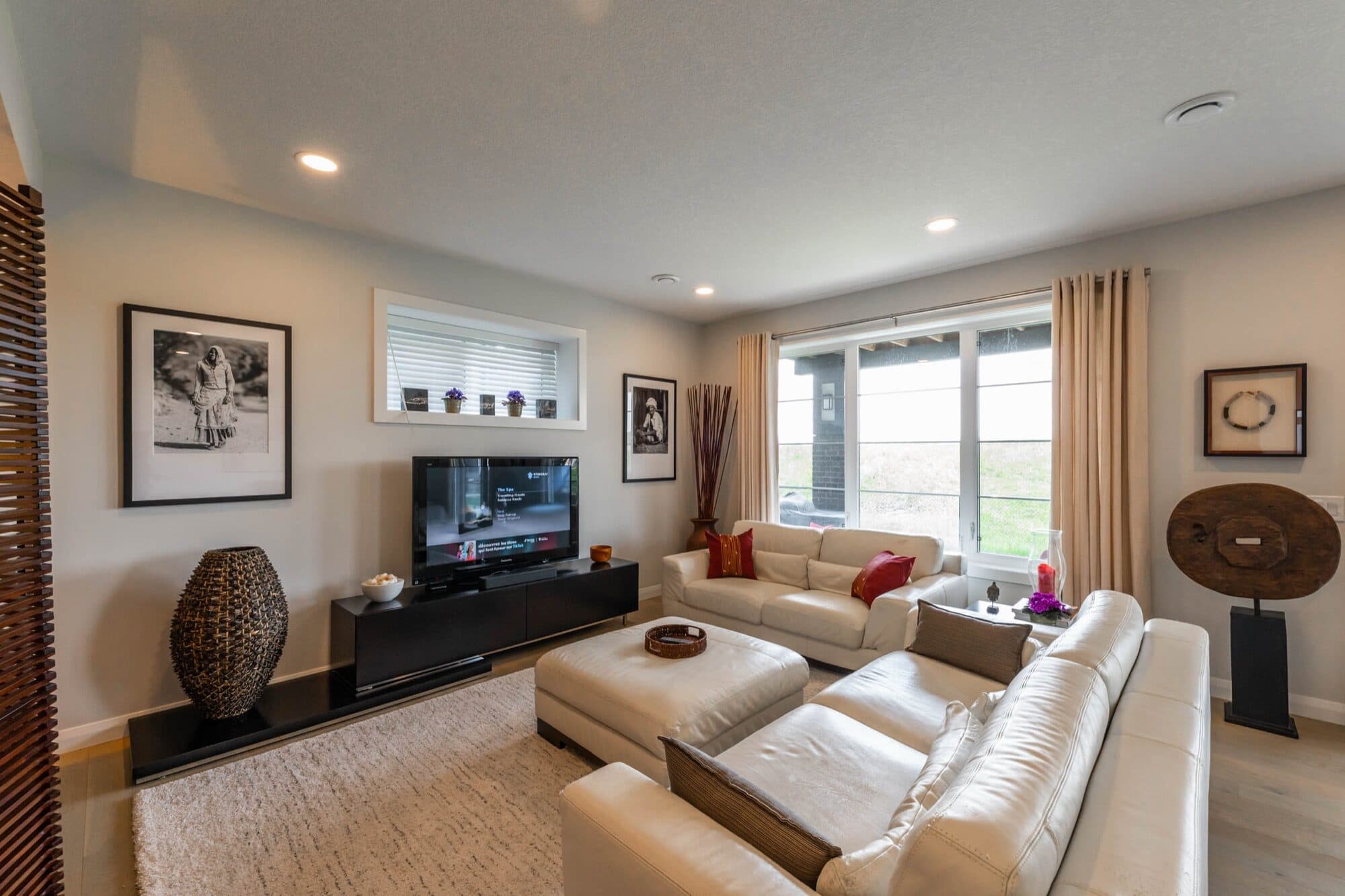 Lounge with white leather sofa and art gallery wall