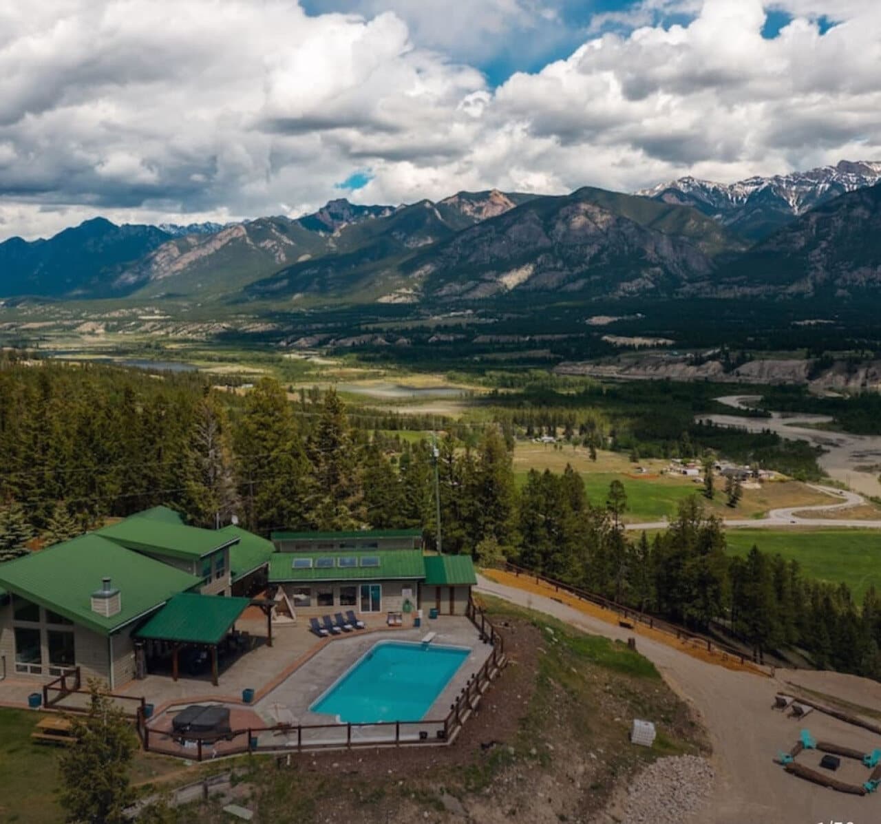 The ReImagine Ranch in the mountains — pool and grounds by ReImagine Builders.