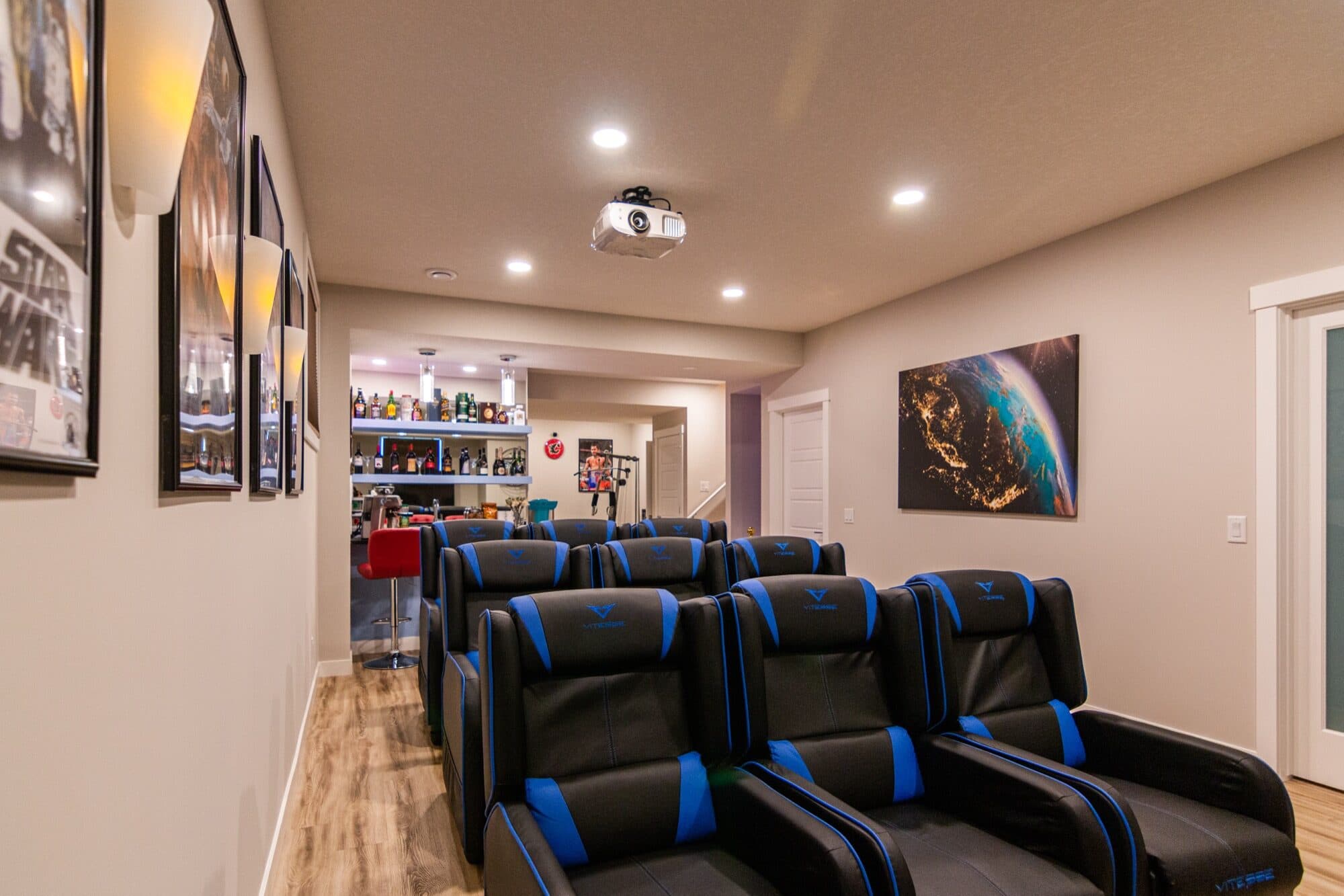 Finished basement home theatre with tiered seating in an Okotoks home