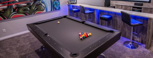 a completed calgary basement build showing a wet bar and pool table